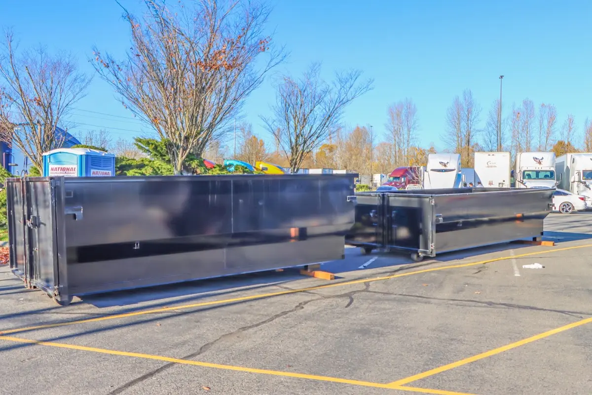 Professional dumpster rental service with roll-off container on residential driveway in Southold